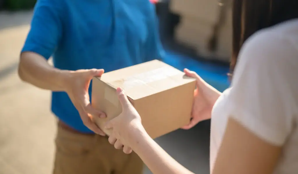 delivery driver handing over a package to a customer