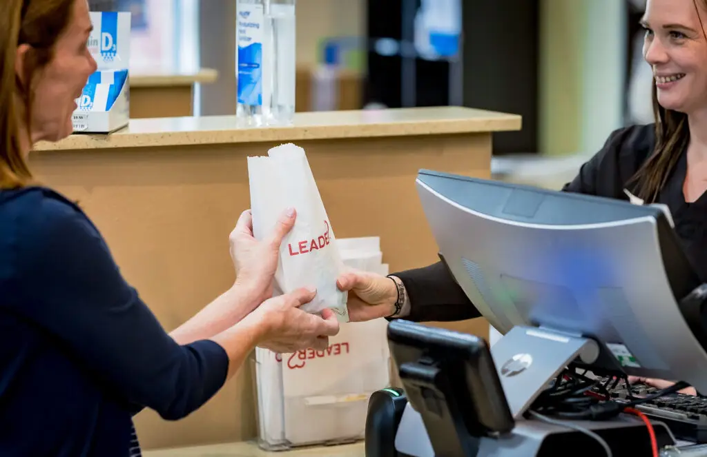 Allen Family Drug - happily handing an prescription over to a patient